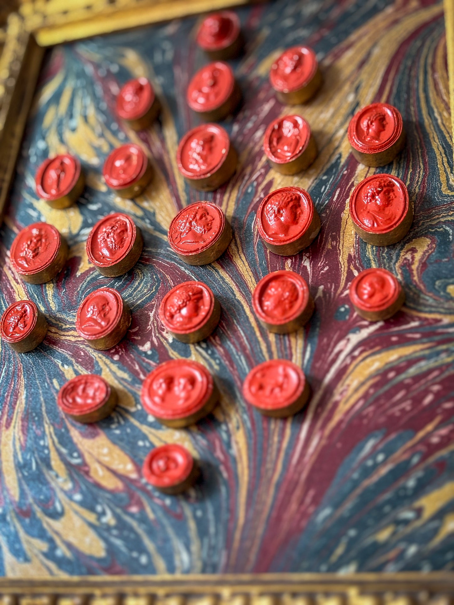 Set of early 19th-century Grand Tour intaglios, cast in plaster and painted in vivid vermilion.