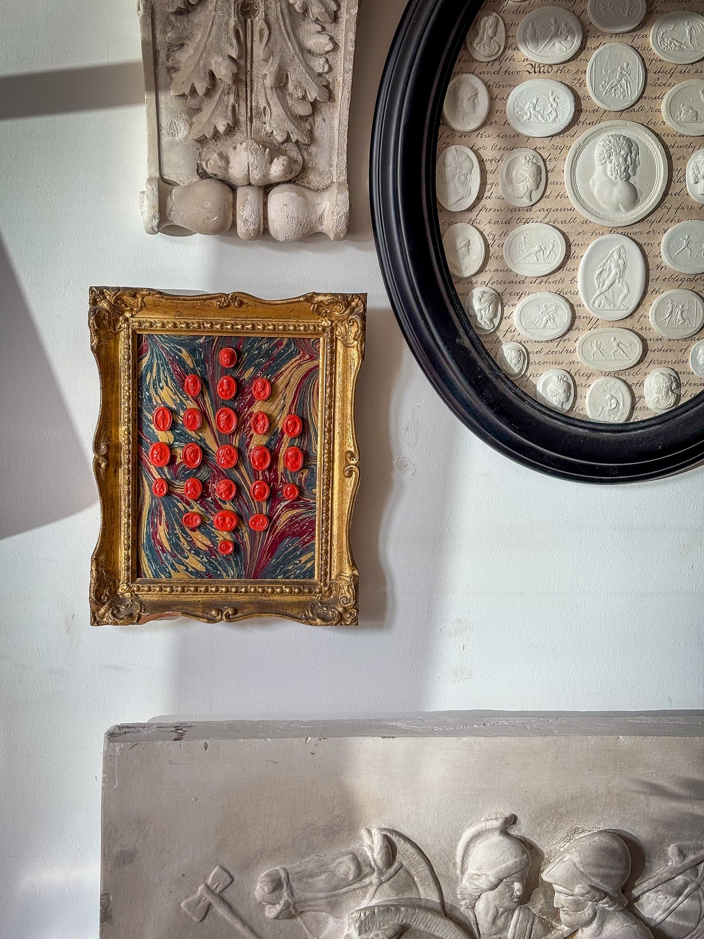 Set of early 19th-century Grand Tour intaglios, cast in plaster and painted in vivid vermilion.