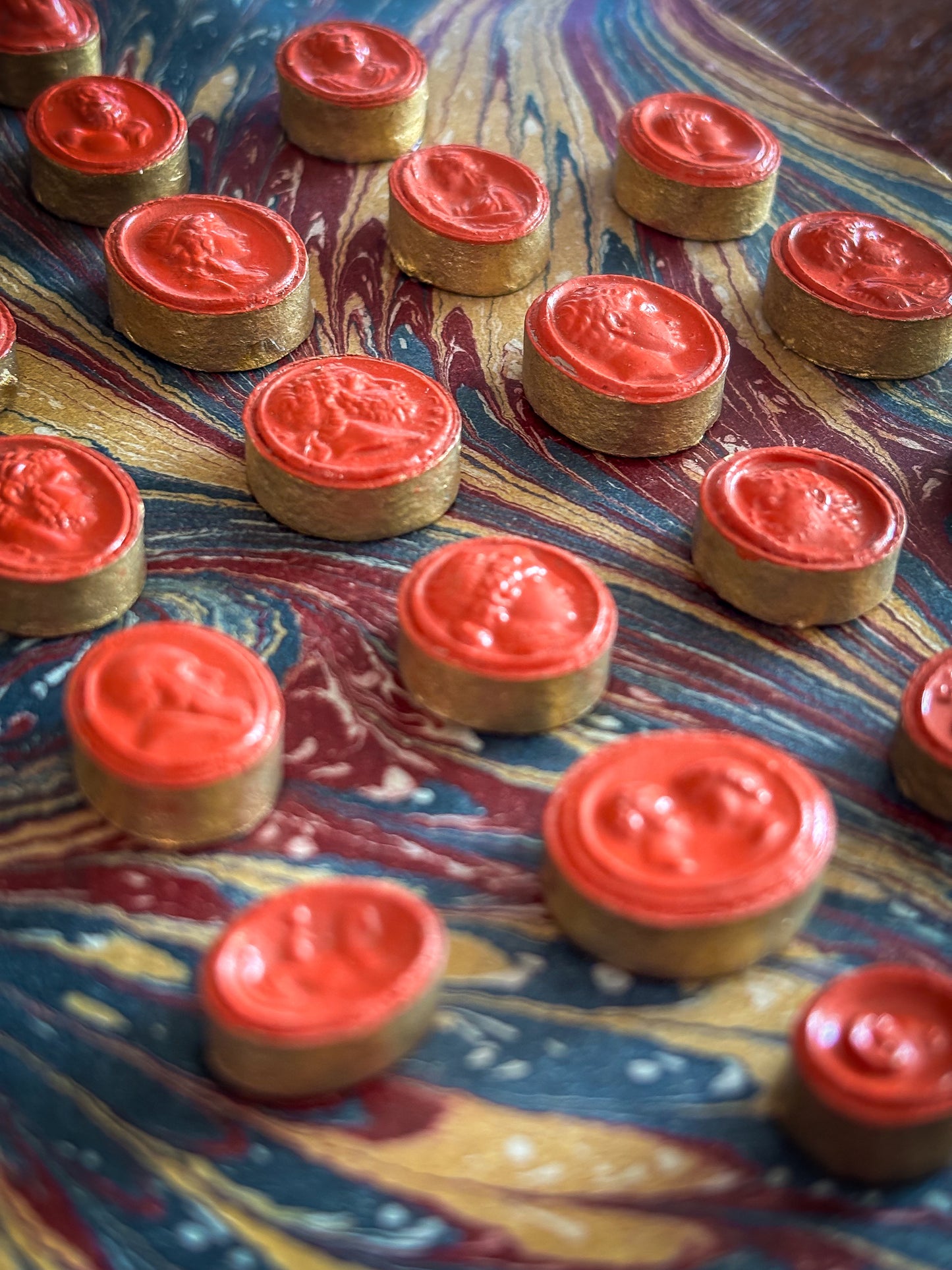 Set of early 19th-century Grand Tour intaglios, cast in plaster and painted in vivid vermilion.