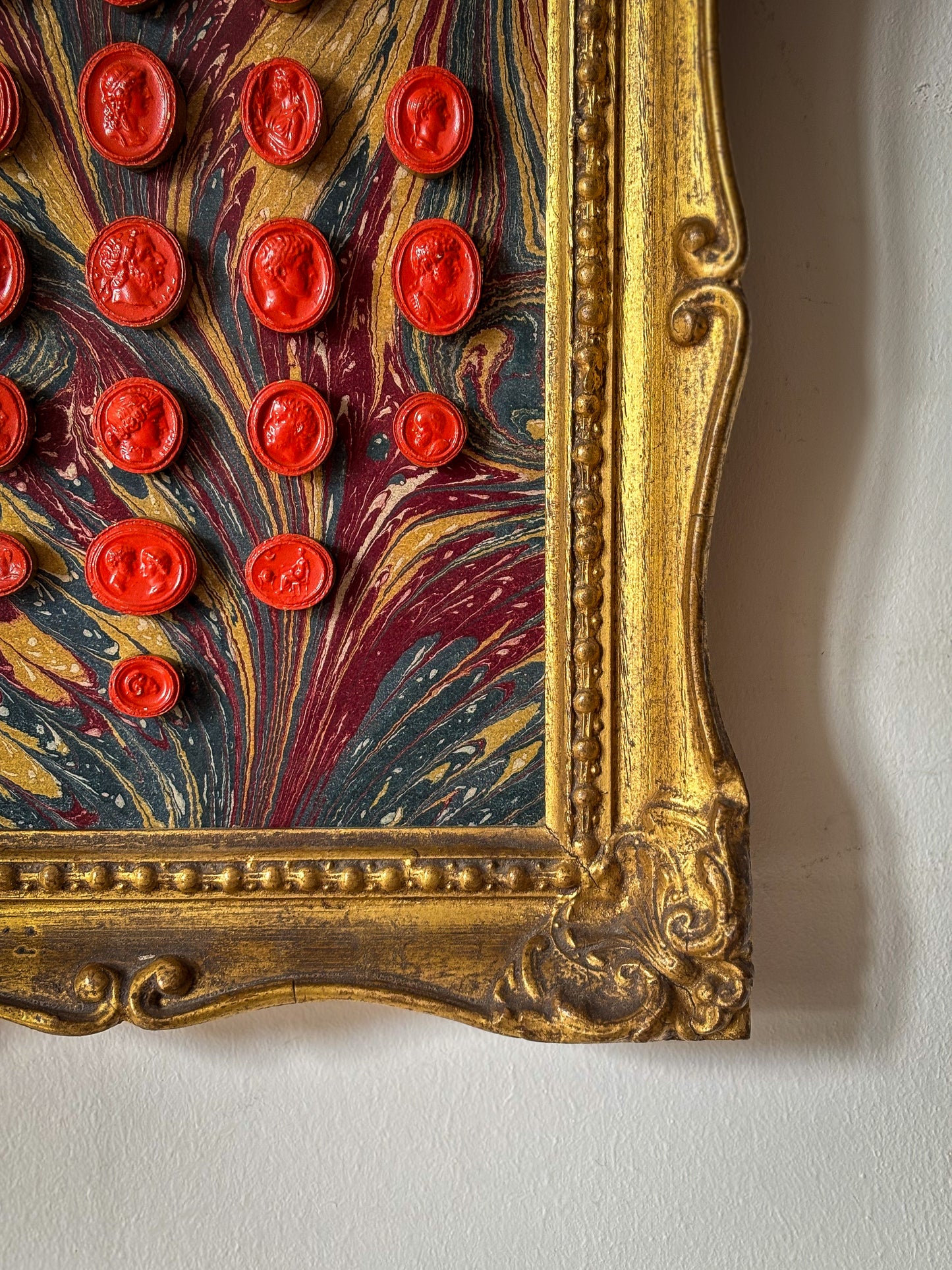 Set of early 19th-century Grand Tour intaglios, cast in plaster and painted in vivid vermilion.