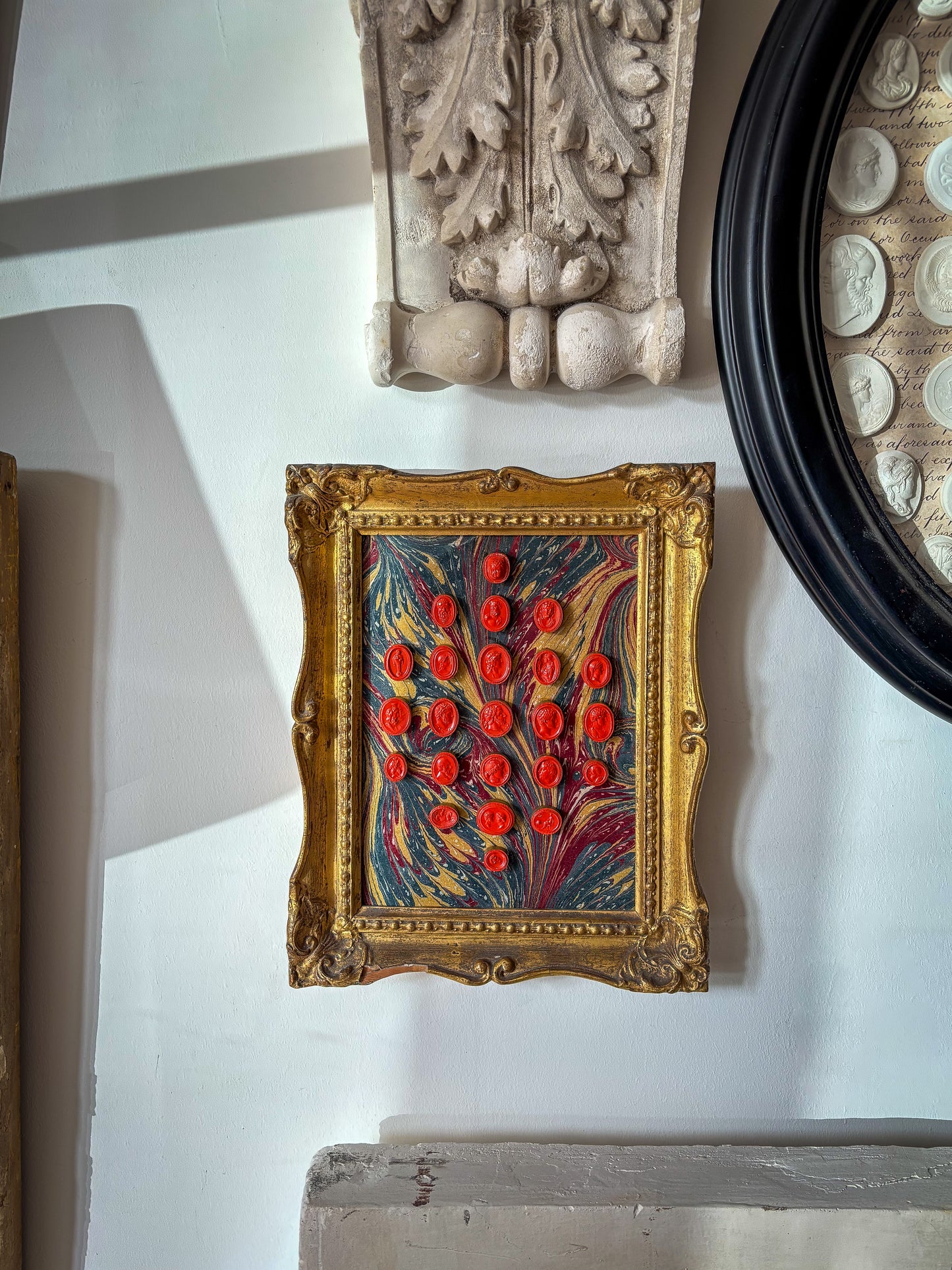 Set of early 19th-century Grand Tour intaglios, cast in plaster and painted in vivid vermilion.